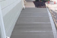 concrete-concrete-walkway-finished-with-forms-near-wall